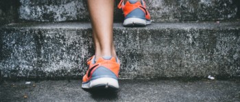 vue sur les chaussures d'une personne montant des escaliers en pierre